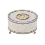 An Elizabeth II oval parcel gilt silver musical box, the lid applied with a shipping scene on