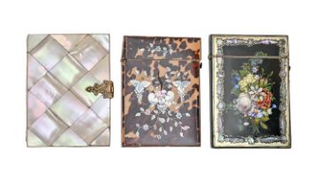 Three Victorian card cases, the papier mache example painted to back and front with flowers in