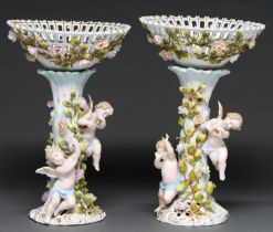 A pair of Plaue floral encrusted fruit stands and detachable baskets, late 19th c, of open trellis