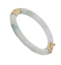 A gold mounted Chinese carved jadeite bangle, 20th c, with engraved mounts, 60mm (internal),