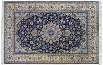 A Kashan medallion rug, mid 20th c, with indigo field, 136 x 221cm Good condition