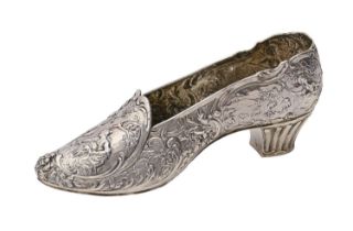 A German silver shoe shaped flower holder, cast and chased with children and flowers within