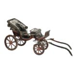 Carriage. A coachbuilt baby phaeton, painted in black and red livery, 164cm l excluding shafts