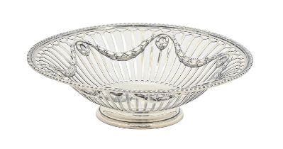 A George V pierced silver sweetmeat dish, in neo classical style, with gadrooned rim, on foot,