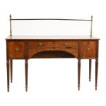 A Regency mahogany sideboard, crossbanded in ebony and line inlaid, with brass rail, arched drawer