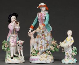 Three Derby figures of a Shepherd playing a reed-pipe, a huntsman’s lady and a girl with a basket,