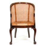 A mahogany-stained beech and caned bergere, early 20th c, on cabriole legs Caning undamaged but