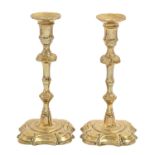 A pair of English brass 'silver' shape candlesticks, c1740, with mushroom knop on moulded foot, 23cm