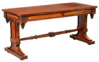 A Victorian gothic rosewood library table, the rectangular crossbanded top fitted with opposing