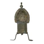 Islamic metalwork. A bronze incense burner, the pierced canopy surmounted by bird finial, on three
