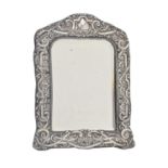 A silver dressing mirror, the bevelled plate in stamped mount, backed on velvet, 30 x 21cm, marks