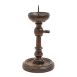 An adjustable mahogany-stained turned wood pricket stick, 18th c or later, on dished foot, with iron
