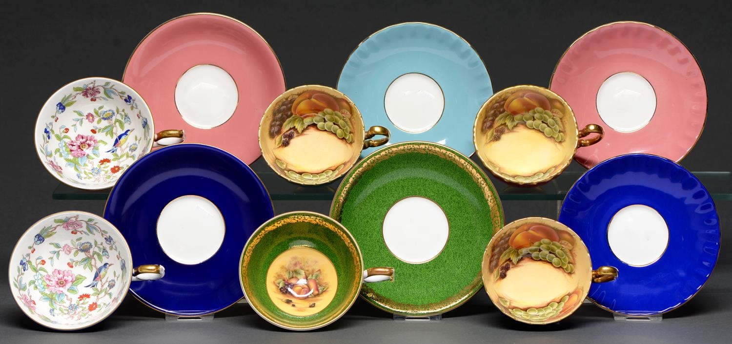 Six Aynsley Harlequin teacups and saucers, second half 20th c, the cups decorated with fruit or