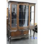A bow centred mahogany and geometrically line inlaid china cabinet, c1910, on cabriole legs with