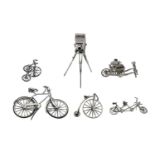 Six Dutch silver toys, 20th century, comprising bicycles, tricycle, grindstone and camera, various