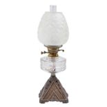 A Victorian oil lamp, with pyramidal cast iron foot and moulded glass fount, brass burner, 54cm h