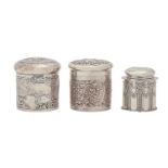 One Victorian and two Edwardian silver dressing table canisters and covers, stamped with garden
