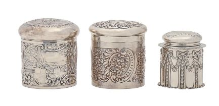 One Victorian and two Edwardian silver dressing table canisters and covers, stamped with garden