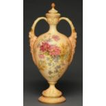 A Royal Worcester vase and cover, 1909, with mask handles and printed and painted with flowers on