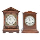 Two oak and stained wood mantel timepieces, c1900, each with triangular pediment, 24 and 28cm h