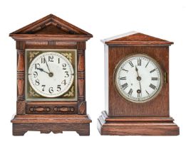 Two oak and stained wood mantel timepieces, c1900, each with triangular pediment, 24 and 28cm h