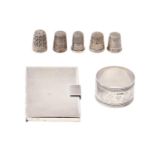 A Victorian silver napkin ring, five silver thimbles and a silver card case, engine turned, 4ozs