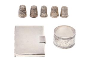 A Victorian silver napkin ring, five silver thimbles and a silver card case, engine turned, 4ozs