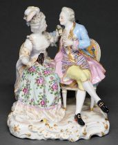 A Samson group of a seated lady and gallant, late 19th c, on oblong gilt base, 20.5cm h,