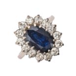 A sapphire and diamond ring, with 9 x 12mm oval sapphire in diamond surround, in 18ct white gold,