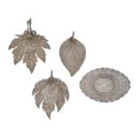 Three South East Asian leaf shaped silver dishes and an oval dish, on four feet, 20th c, various