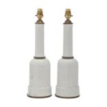 A pair of brass mounted white glazed earthenware table lamps, late 20th c, in art deco style, 41cm h