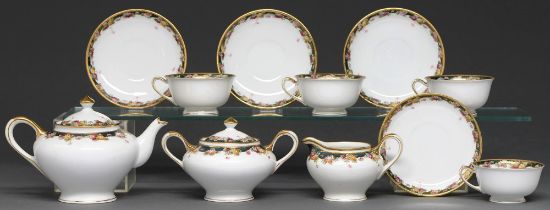 A Noritake tea service, 20th c, with floral border and gilt handles, teapot and cover, 11cm h,