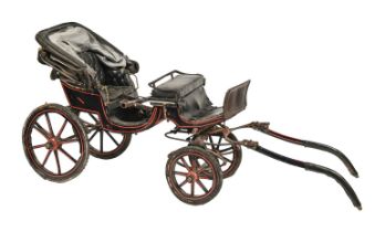 Carriage. A coachbuilt baby phaeton, painted in black and red livery, 164cm l excluding shafts