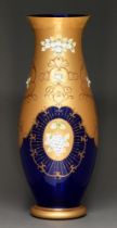 A Bohemian cobalt glass vase overlaid with gilt and enamel flowers, late 20th c, 59.5cm h Good