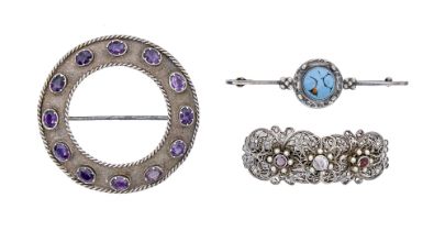 An Arts & Crafts circular silver and amethyst brooch, 62mm diam and two others, 44g (3) Good