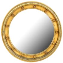 A Victorian circular giltwood mirror, the cavetto frame with balls at intervals, 59cm diam