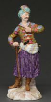 A German porcelain figure of a Turk, c1900, in richly enamelled and gilt costume, 24cm h, spurious