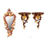 A pair of mahogany-stained and gilt carved wood wall brackets and a mirror, late 20th c, in Rococo