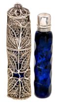 A faceted blue glass scent bottle and threaded silver cap and an associated silver filigree scent