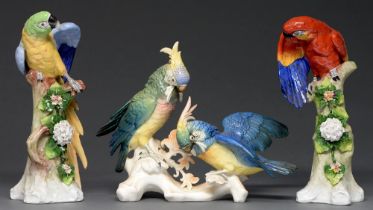 A pair of Sitzendorf parrots, 32cm h and a Karl Ens group of cockatoos, mid 20th c