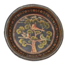 A Persian papier-mâché charger, 19th c, painted with three birds in a tree on a black ground,