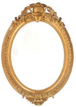 A Victorian oval giltwood and composition mirror, the bevelled plate in beaded surround and egg-