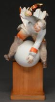 A Meissen figure of Baron von Munchausen astride the moon, 20th c, designed by Alexander Struck,