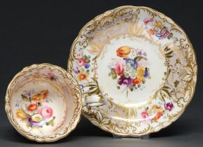 A Coalport coffee cup and saucer, c. 1830, painted with sprigs of country flowers, reserved on a
