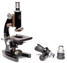 A Baker compound microscope, several lenses and accessories, including a camera attachment and two
