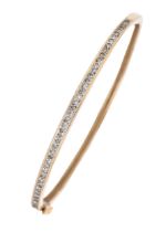 A diamond bangle, in 9ct gold, 58mm (internal), marks rubbed, 8.9g Slight wear scratches