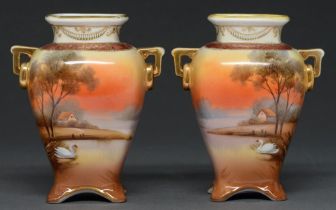 A pair of Noritake two handled vases, decorated with swans in a riverside landscape, 14cm h Gilt