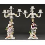 A pair of German porcelain figural three branch candelabra, 42cm h