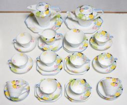 An Art Deco Paragon bone china tea service, c1932, decorated with colourful flowers, lidded jug