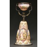 A Viennese silver gilt and painted enamel wager cup, early 20th c, in the form of a woman, her